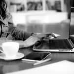 A woman typing on a laptop