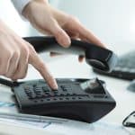 man dialing office phone