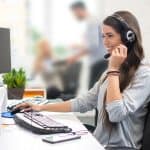 woman answering phone with headset