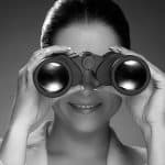 lady searching with binoculars black and white photo