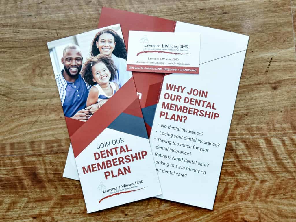 brochure for dental membership plan on table - Golden Proportions Marketing