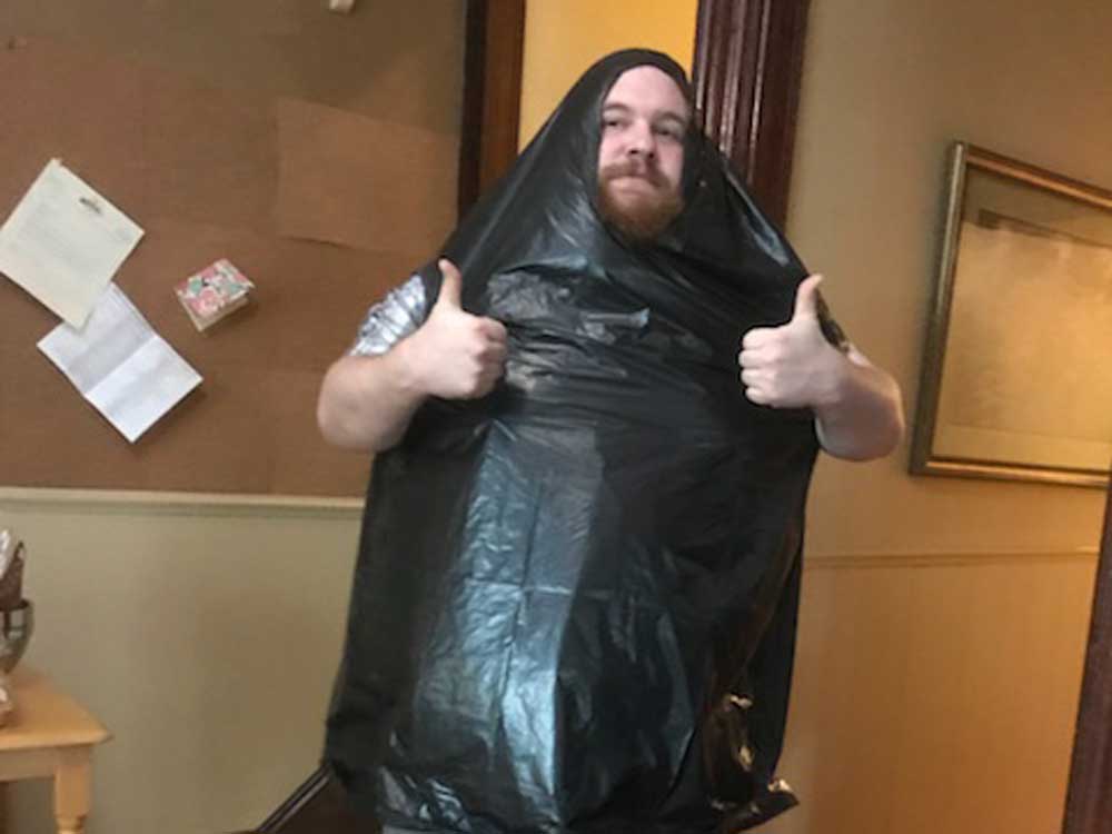 jake wearing a trashbag to grill in the rain - Golden Proportions Marketing