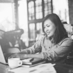 A woman typing on a computer - Golden Proportions Marketing